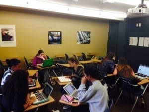 Students working on their computers in a classroom.