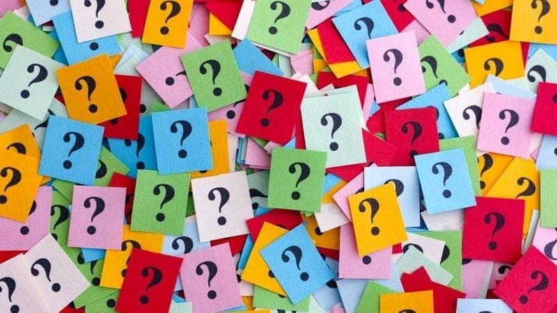 A pile of question marks on colorful sticky notes