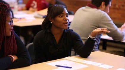 A young woman sharing in a classroom environment